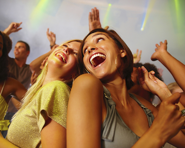 Closeup of laughing young girls enjoying at nightclub